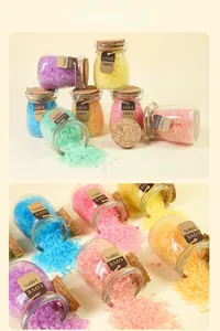 Macro shot of colorful Himalayan bath salts in small glass jars with wooden corks and tags