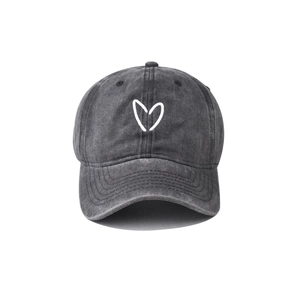 Washed dark gray cotton baseball cap with white heart embroidery and a vintage finish
