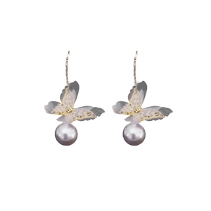 Elegant butterfly mesh pearl earrings with sparkling crystal accents in a soft violet tone