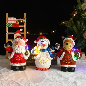Figuras navideñas de resina con LED con Papá Noel y reno sobre base de piel sintética