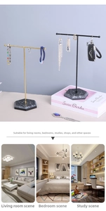 Detail view of T-bar jewelry stands with marble bases for necklaces and earrings