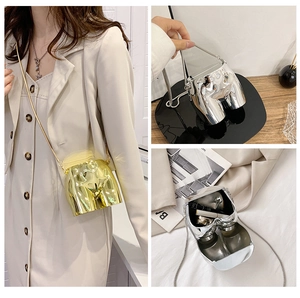 Detail of creative gold and silver metal body shaped mini bags with thin chain straps