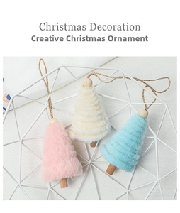 Detailed view of plush Christmas tree ornaments in pink, white, and blue with wooden base
