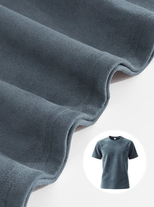 Detailed view of gray-blue knit t-shirt fabric texture and reinforced double-stitching