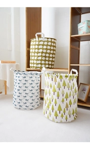 Foldable fabric laundry baskets with hedgehog, whale, and tree prints in a home setting