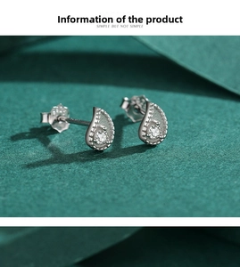 Close-up of minimalist S925 sterling silver paisley stud earrings with round white zircon