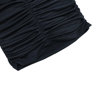 Detailed view of the black ruched fabric texture and elastic stitching on this long dress