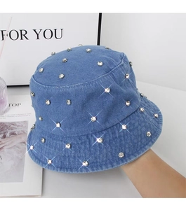 Detail of blue washed denim bucket hat featuring sparkling rhinestones and textured fabric