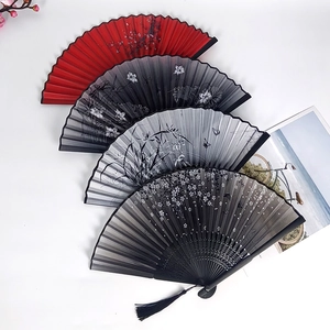 Classical Chinese folding fans with floral patterns, bamboo frames, and elegant tassels