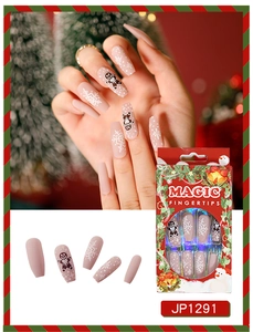 Close-up of matte nude pink Christmas press-on nails with snowflakes and gingerbread man