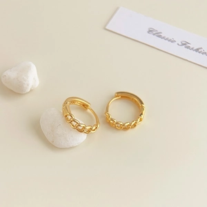 Close-up of 18K gold plated hoop earrings with classic woven chain texture detail