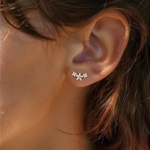 Elegant S925 sterling silver flower stud earrings with marquise zircon stones on model