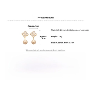 Detail view of gold-plated flower earrings with zircon petals and round faux pearls