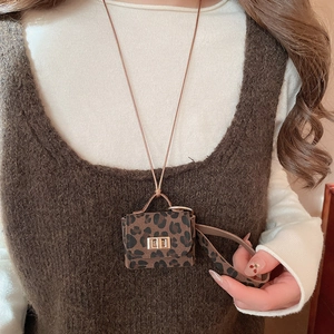 Detailed view of leopard print mini bag pendant with gold twist lock and neck strap