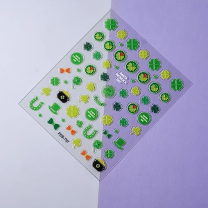 Detailed view of St. Patrick's Day nail stickers featuring green clovers and gold horseshoes