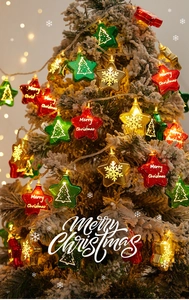 Vibrant star-shaped Christmas string lights with Merry Christmas text on a snowy tree