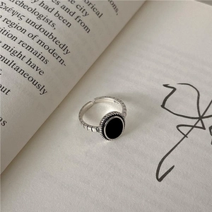 Detailed macro view of S925 sterling silver ring featuring an oval black onyx gemstone