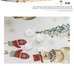 Close-up of waterproof Christmas snowman tablecloth with water beads on fabric