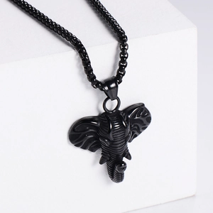 Black stainless steel elephant pendant necklace with box chain on a white display pedestal