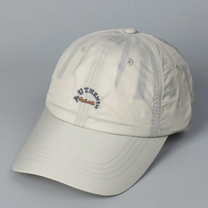 Detail of light beige quick-dry baseball cap featuring double layered authentic embroidery