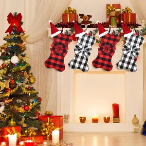 Dog bone shaped Christmas stockings in plaid pattern hanging on a decorated fireplace