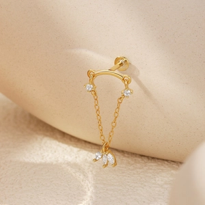 Detailed macro view of S925 sterling silver gold crown earring with zircon chains