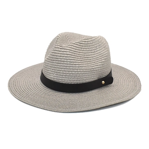Detail of grey paper straw hat with black leather band and gold metal stud decoration