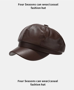 Detail of dark brown PU leather newsboy hat with refined texture and top button