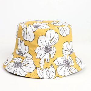 Detailed close-up of yellow floral bucket hat featuring white hand-painted flower patterns