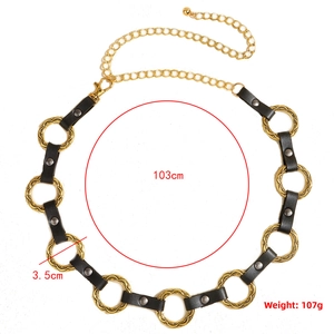 Detail view of gold metal rings and black leather waist chain with size markings