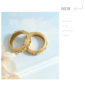 Detail of vintage gold rings featuring embossed sun and moon patterns with zircon insets
