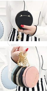 Detail view of mini cat-ear coin purses with zipper and gold lobster clasp keychain