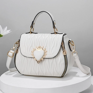 Elegant white quilted shell shoulder bag with gold heart crown buckle and strap