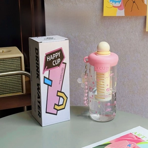 Close-up of floral water cup with pink lid, infuser filter, and matching gift box pack