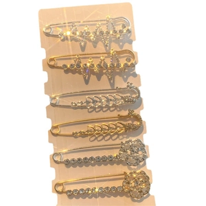6-piece set of rhinestone brooch pins with swan and floral motifs on golden and silver bases