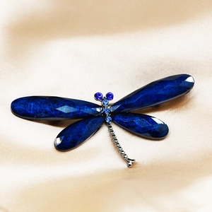 Exquisite dragonfly brooch featuring deep blue faceted crystals and shimmering rhinestones