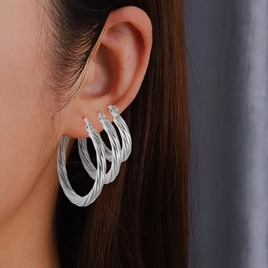Three-piece set of silver twisted hoop earrings in various sizes for women