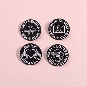 Set of black enamel pins with book club skull and pistol designs on pink background
