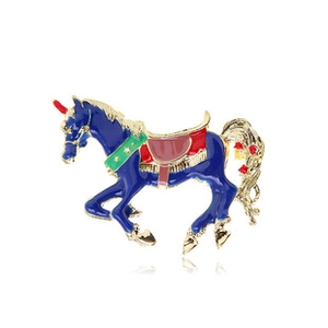 Macro detail of blue enamel horse brooch with gold accents and colorful saddle