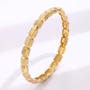 Minimalist faceted gold-plated geometric bracelet with matte texture and metallic finish