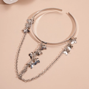 Detailed view of silver butterfly armlet featuring elegant cascading fringe chains