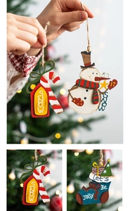 Detail of wooden Christmas ornaments featuring SNOW and LET IT SNOW text for holiday decor