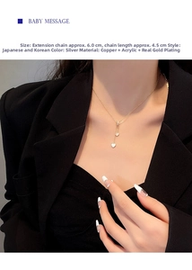 Nahaufnahme von doppelten Herzanhängern an einer Goldkette, getragen von einem Model