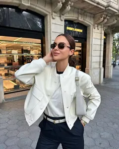 Detail view of a white stand collar jacket with large pockets for women's street style