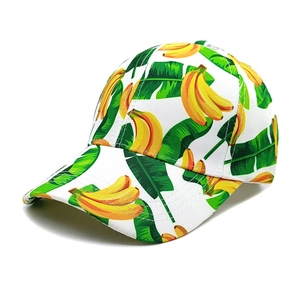 Close-up of breathable fabric with yellow banana and green leaf print on baseball cap
