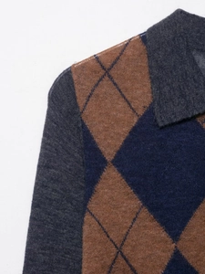 Detail of diamond pattern knit polo collar and shoulder stitching texture in navy and brown
