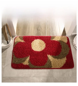 Macro detail of the plush floral mat with reinforced edge stitching on wood floor