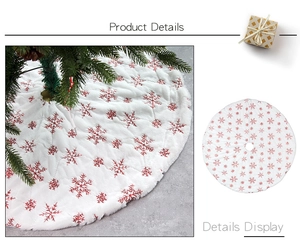 Detail of plush white Christmas tree skirt with embroidered red sequins snowflake pattern