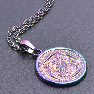Macro shot of iridescent rainbow owl pendant in stainless steel with Greek letters