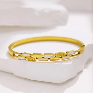 Gold stainless steel heart bracelet with white enamel and LOVE engraving on stone base
